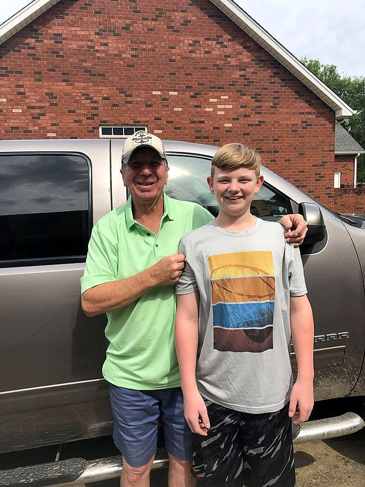 Mark Vest, owner of Apex Plumbing & Electrical, with his grandson beside his truck in Columbia, MS