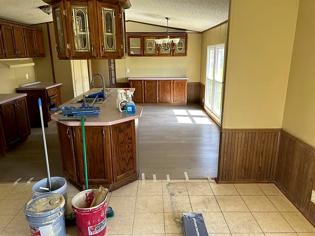 Kitchen and dining remodel in progress with new flooring going down